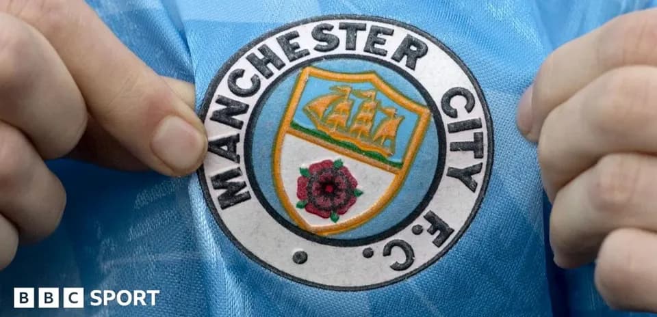 Persona mostrando el escudo de Manchester City FC