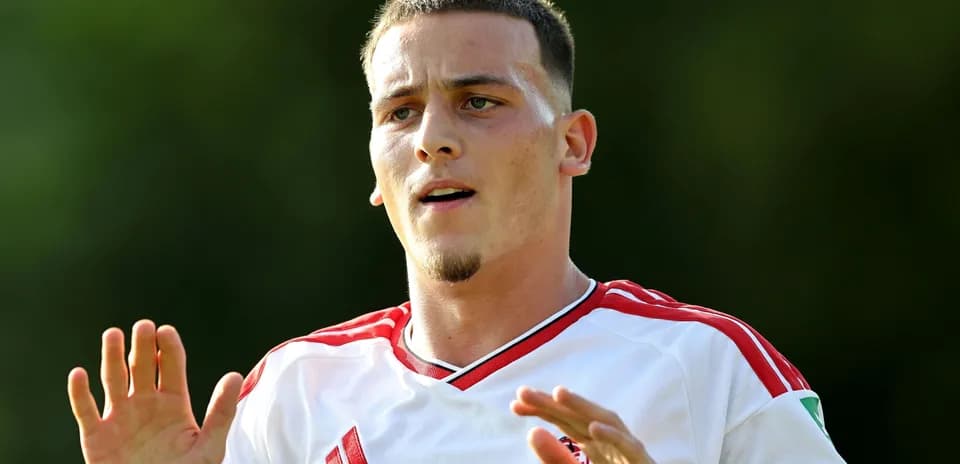 Jugador con camiseta blanca gesticulando durante entrenamiento