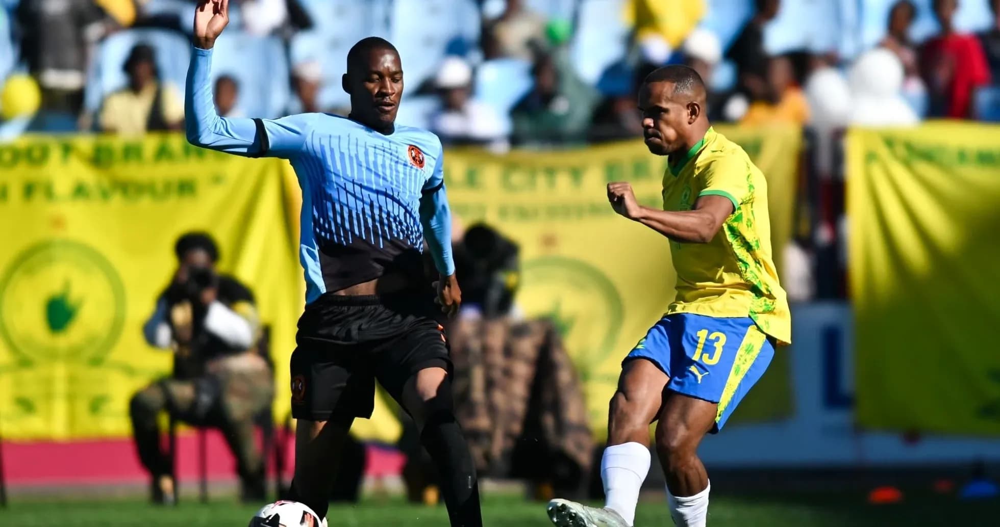 Jugador de amarillo pateando el balón durante partido