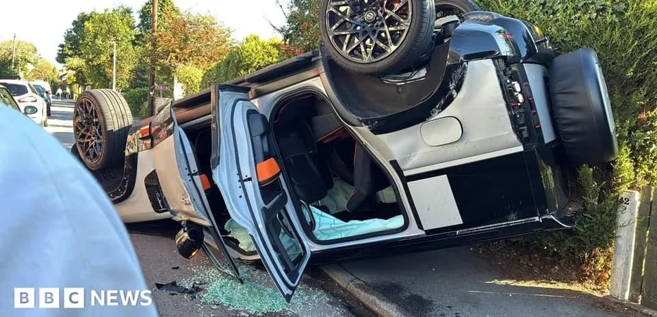 Coche volcado en una calle con cristales rotos