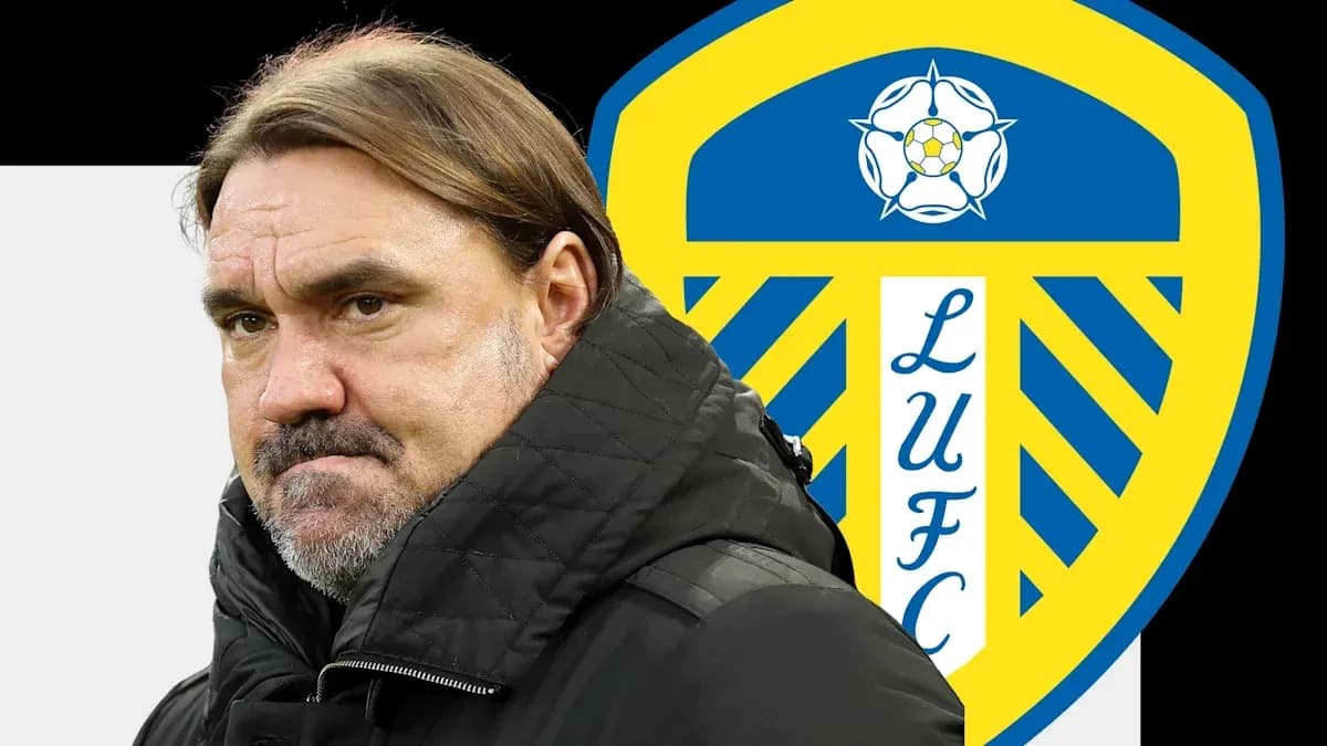 Entrenador de pie frente al escudo de Leeds United