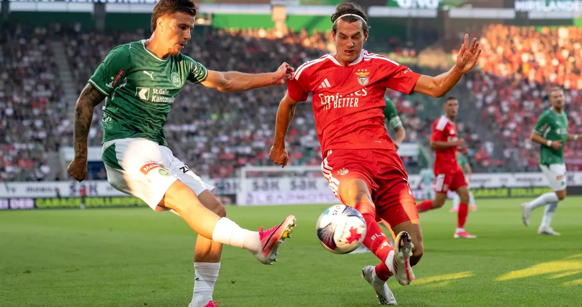 Jugadores de Benfica y FC St. Gallen compiten por el balón