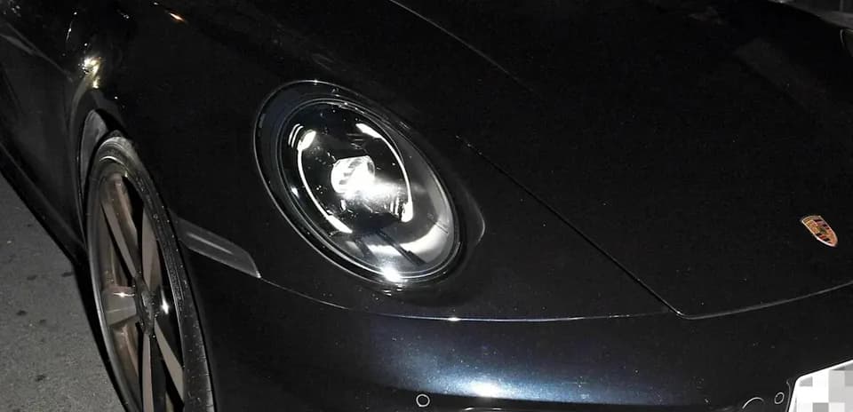 Dos hombres en un coche deportivo negro