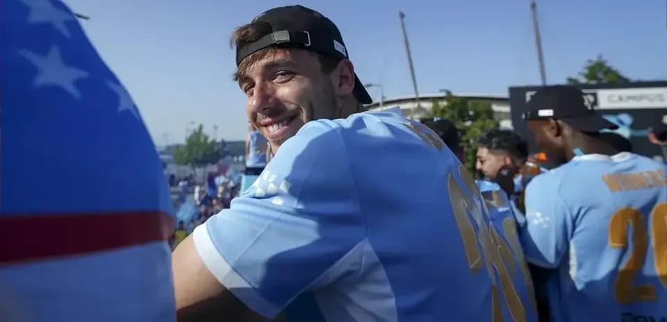 Jugador sonriendo en celebración con equipo