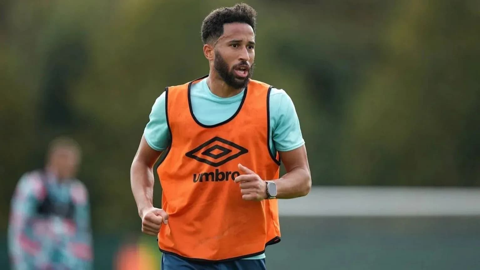 Jugador entrenando con chaleco en campo de fútbol
