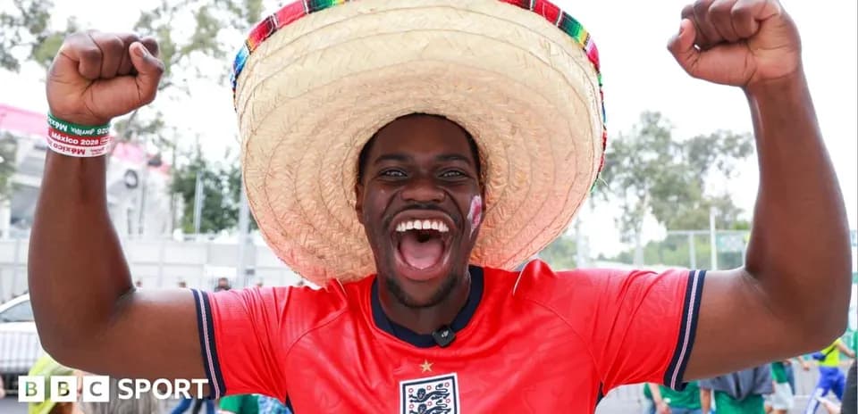A fan in a sombrero celebrating at a stadium
