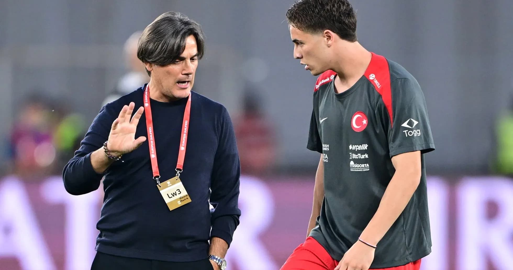 Entrenador hablando con jugador durante calentamiento