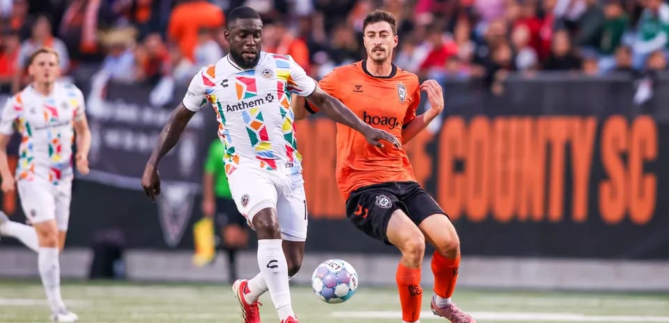 Jugador persiguiendo el balón en partido de fútbol