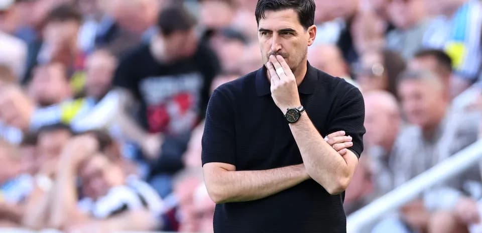 Entrenador pensativo en el banquillo durante el partido
