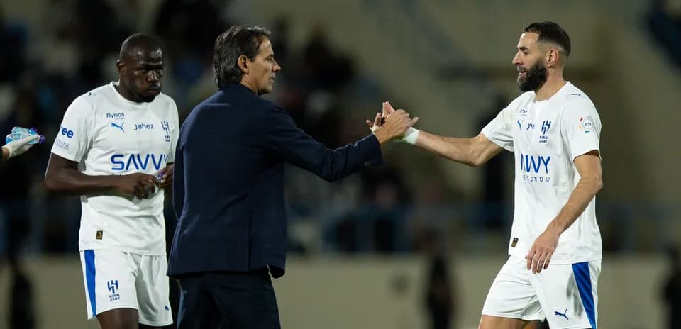 Entrenador saludando a jugador en partido de fútbol