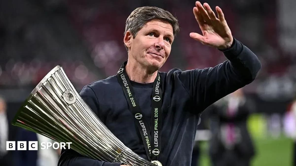 Entrenador levantando trofeo y saludando al público