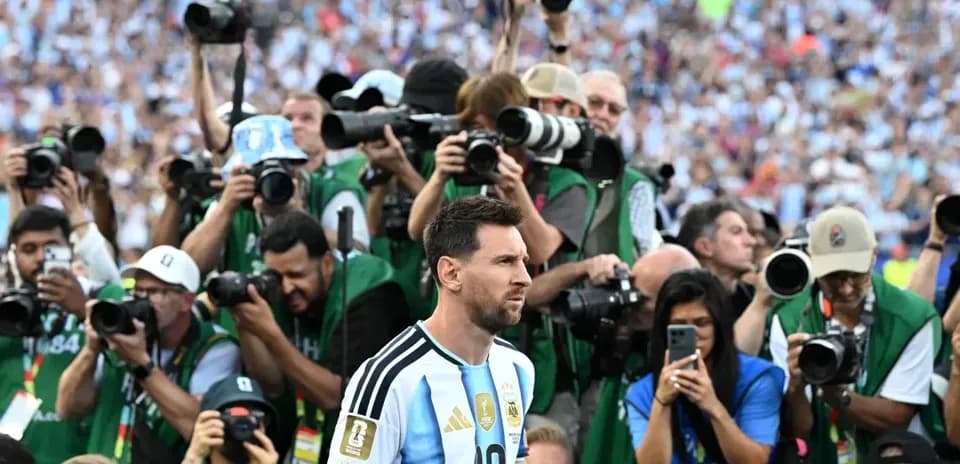 Lionel Messi surrounded by photographers at stadium