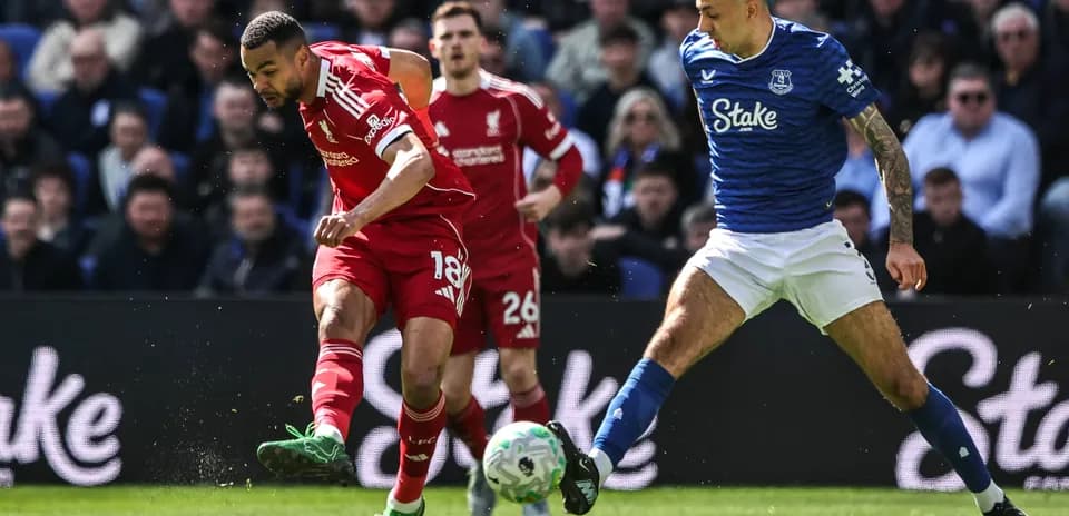 Jugador de Liverpool driblando mientras es presionado por rival