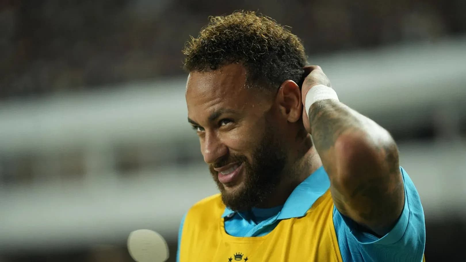 Jugador con camiseta amarilla en el banquillo