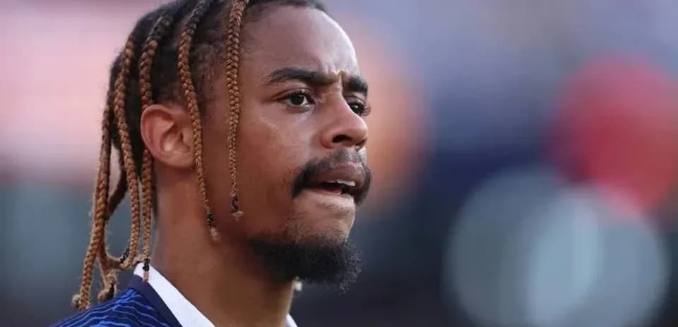 Jugador con trenzas en campo de fútbol