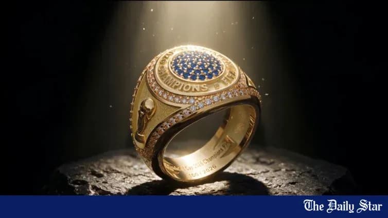 An illuminated championship ring on a dark surface