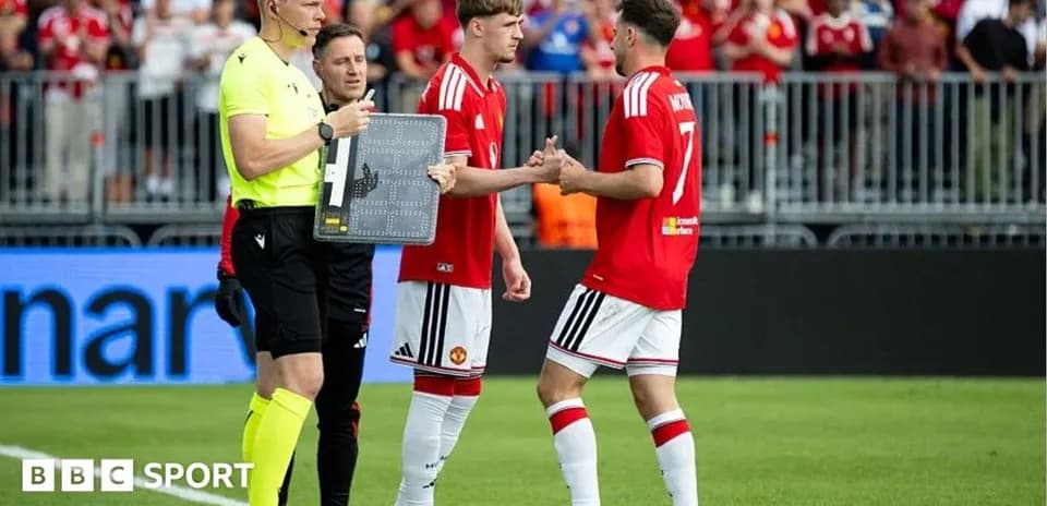 Jugadores de Manchester United realizan un cambio durante el partido