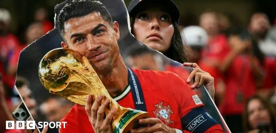 Fan holding a cutout of Cristiano Ronaldo with trophy