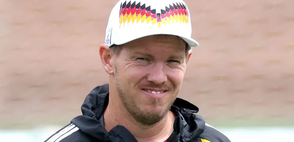 Entrenador sonriente con gorra en campo de entrenamiento