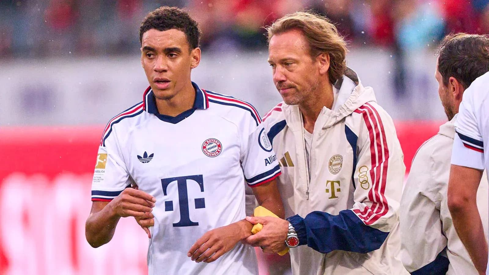 Jugador de Bayern Munich siendo atendido por entrenador Jugador de Bayern Munich siendo atendido por entrenador