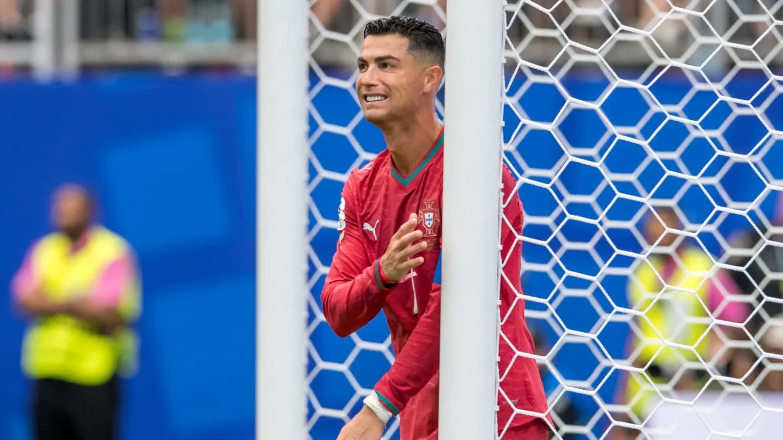 Cristiano Ronaldo celebrating behind the goal net Cristiano Ronaldo celebrating behind the goal net
