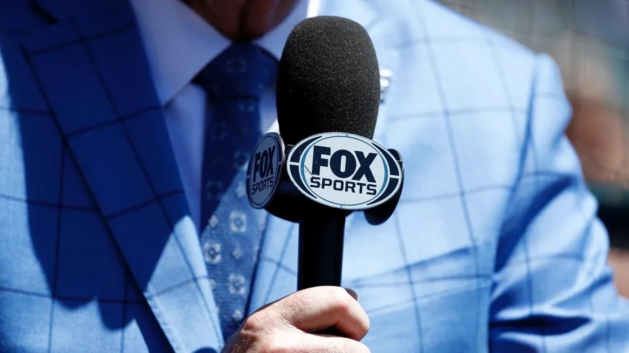 Mic with FOX Sports logo held by a person Mic with FOX Sports logo held by a person