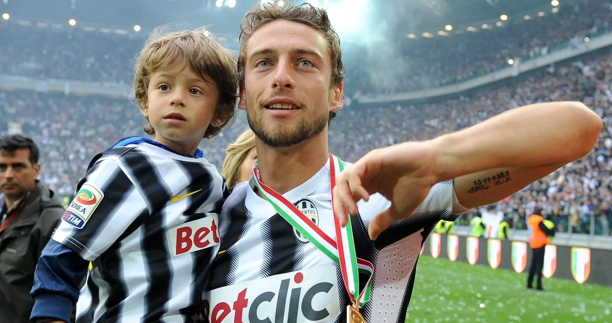 Jugador levantando a un niño tras un partido Jugador levantando a un niño tras un partido