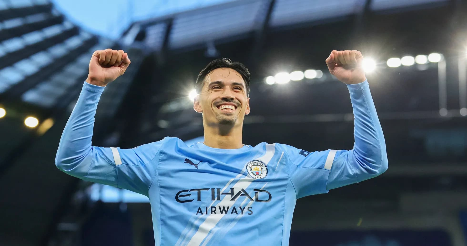 Jugador de Manchester City celebrando con los brazos en alto Jugador de Manchester City celebrando con los brazos en alto