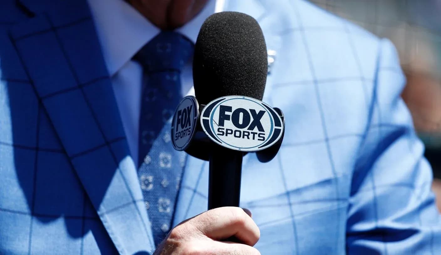 Mic labeled 'FOX Sports' held by a person Mic labeled 'FOX Sports' held by a person